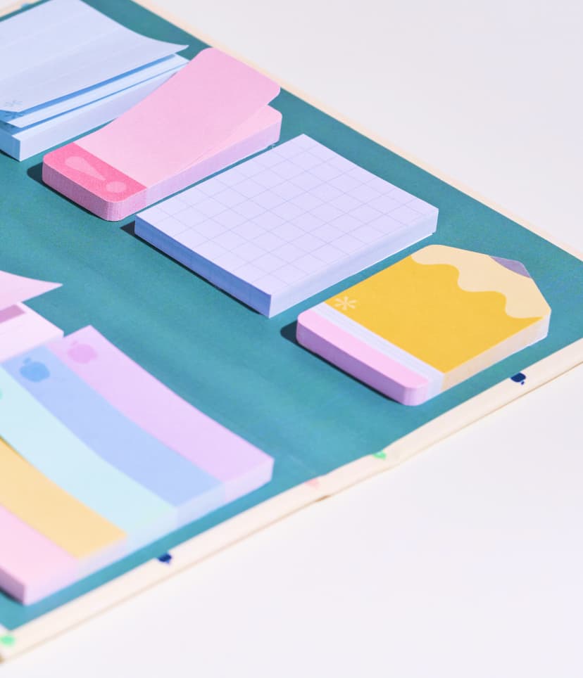 Softbound teacher lesson planners featuring new designs. Close up view of softbound planners featuring reflective and shiny paper edges. Woman holding a teacher lesson planner featuring hexagon design.