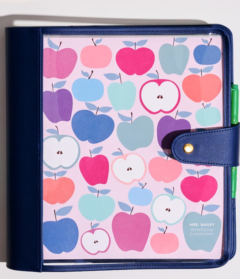 Softbound teacher lesson planners featuring new designs. Close up view of softbound planners featuring reflective and shiny paper edges. Woman holding a teacher lesson planner featuring hexagon design.