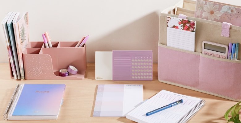 Desk with assorted planner accessories and writing tools