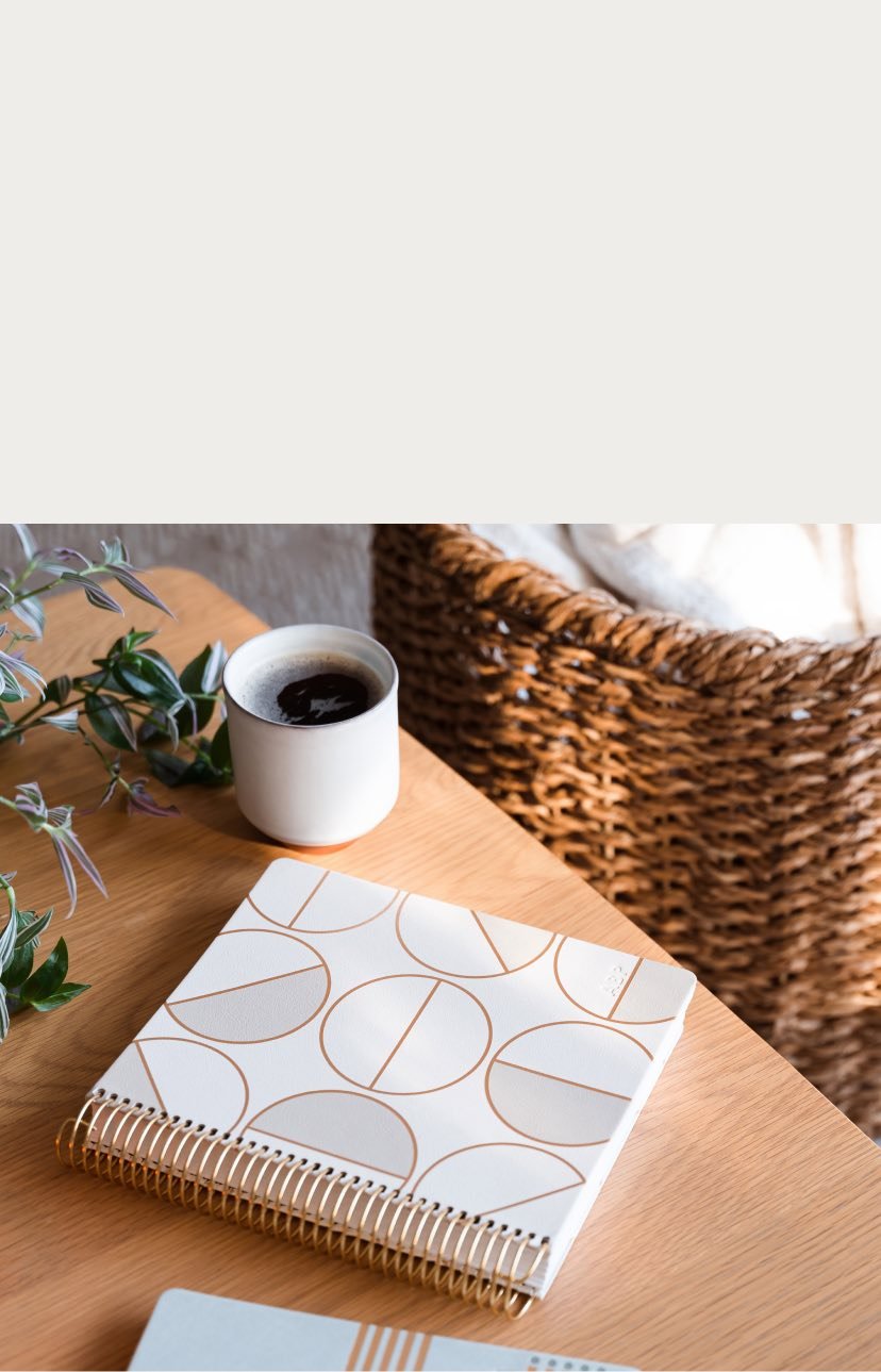 Focused Planner on a wooden table next to cup of coffee.