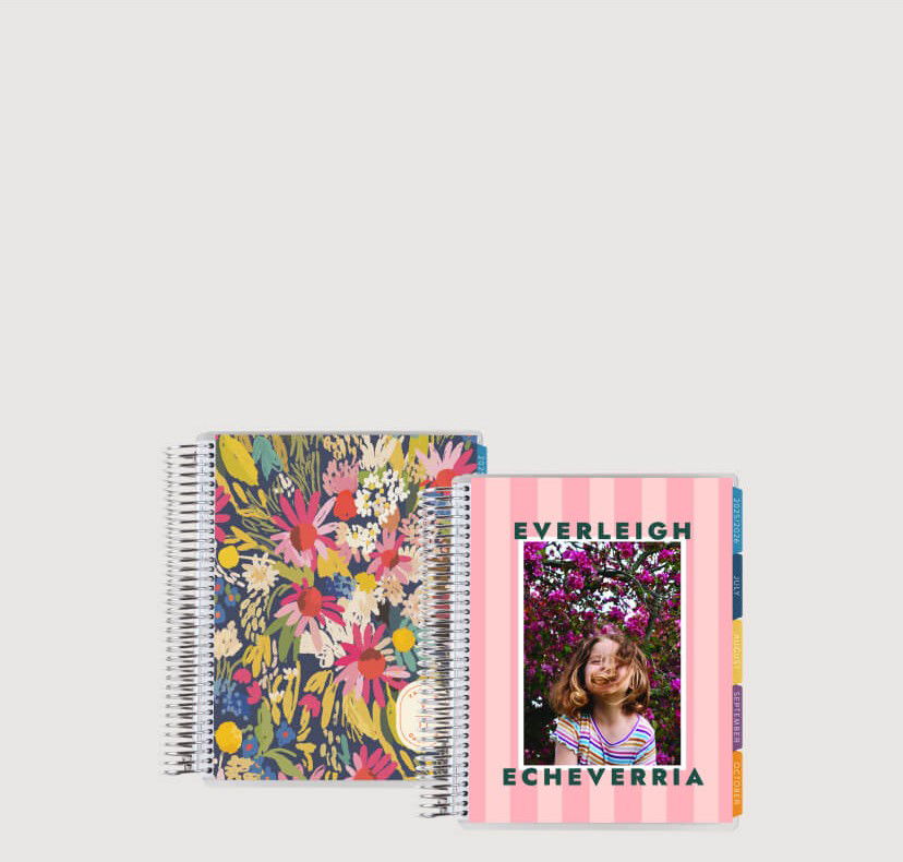 Buy One, Get One 50% OFF Interchangeable Covers. Image of closed planners on a grey background. Click to shop now.
