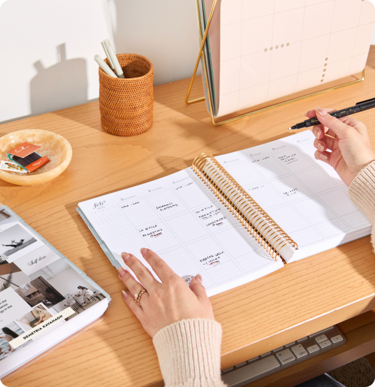 Coiled guided journals and notebooks on a table.