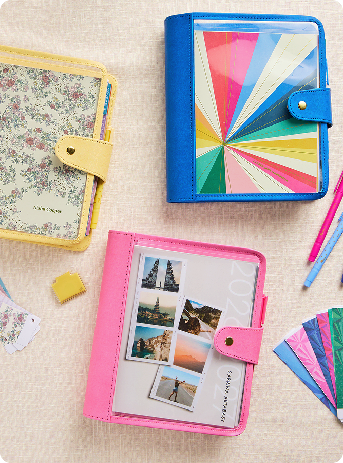 stack of colorful coiled lifeplanners and ring agendas.
