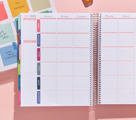 open teacher planner stacked on top of a closed planner