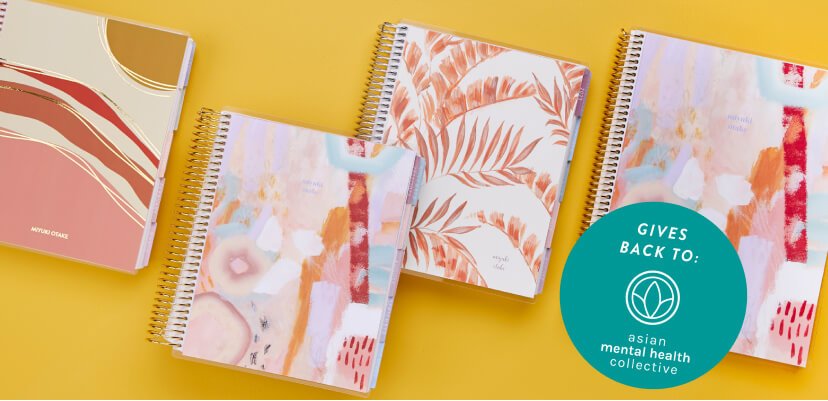 overhead view of assorted AANHPI heritage designs on coiled planners and notebooks