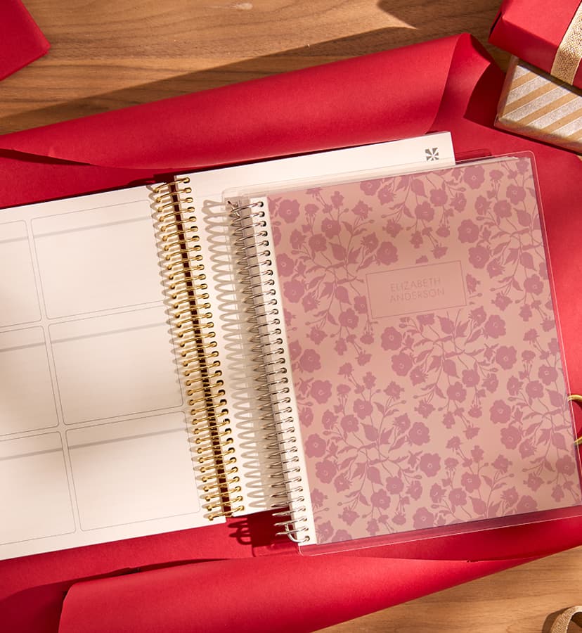 two stacked coiled custom notebooks, one featuring ping monochrome floral design. Click to shop custom notebooks