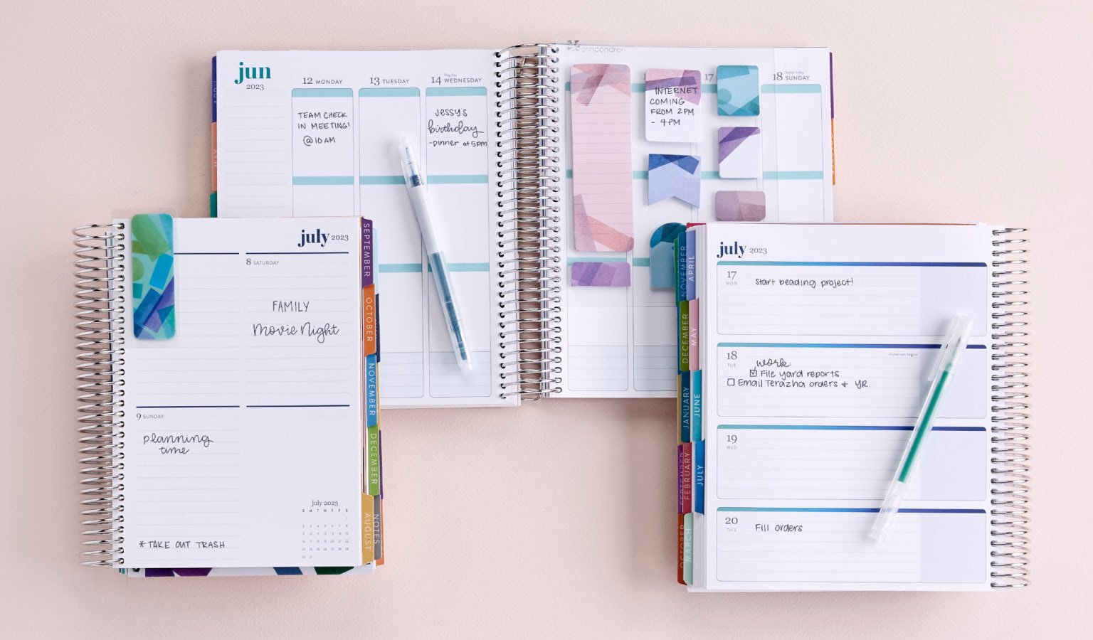 Overhead view of three Coiled Weekly Lifeplanners featuring different layout options including our 7″ x 9″ Vertical Layout, New A5 compact Vertical Layout, and 7″x 9″ Horizontal Layout