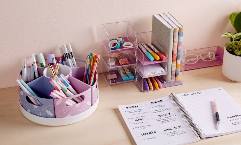 view of assorted desk organizers, accessories, and notebooks on a wooden table