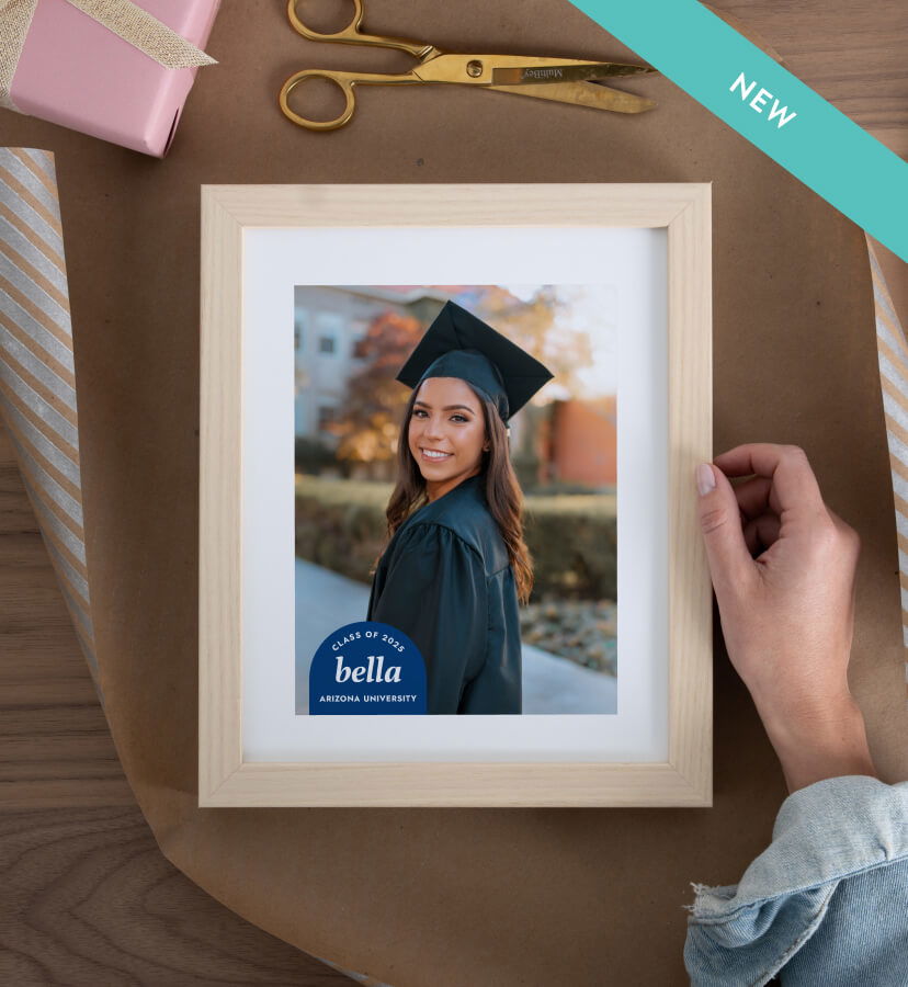 Framed photo art of graduate being wrapped as a gift.