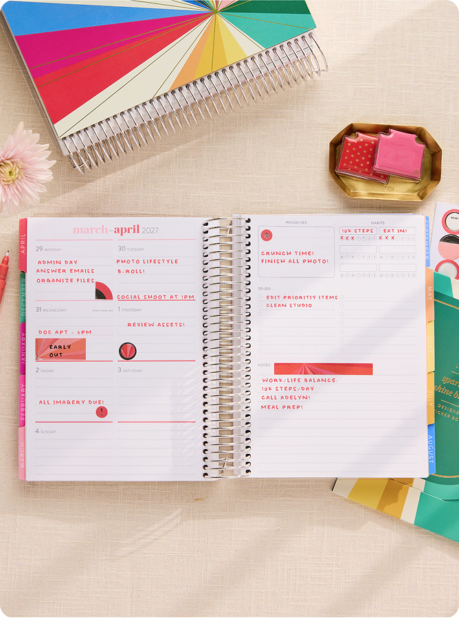 Close up of coiled lifeplanner featuring daily layout with notes and stickers.