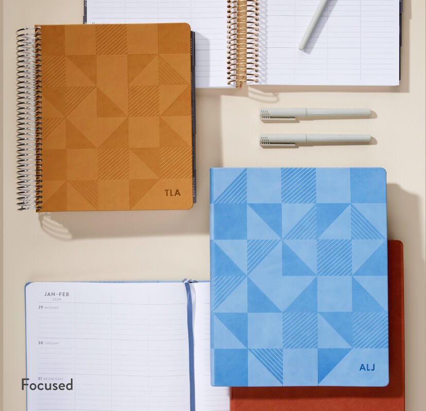 overhead view of assorted focused teacher lesson planners