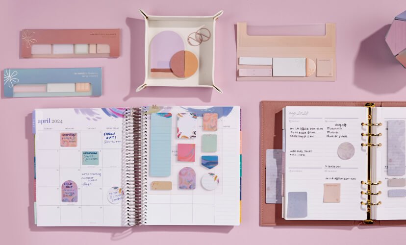 overhead view of assorted planners featuring sticky notes