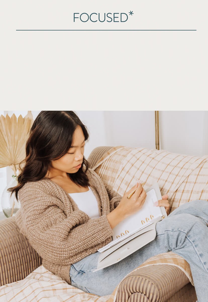 woman laying on couch flipping through Focused Ring Agenda