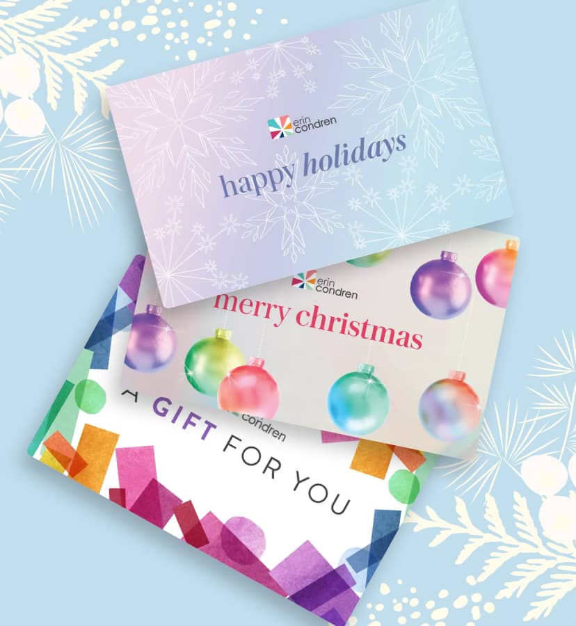 assorted gift cards showcasing holiday designs stacked on a light blue background.