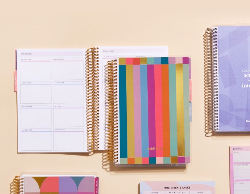 Productivity tools including coiled planners, notepads and accessories.