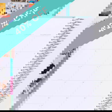 coiled monthly planner showing monthly layout. click to shop now.