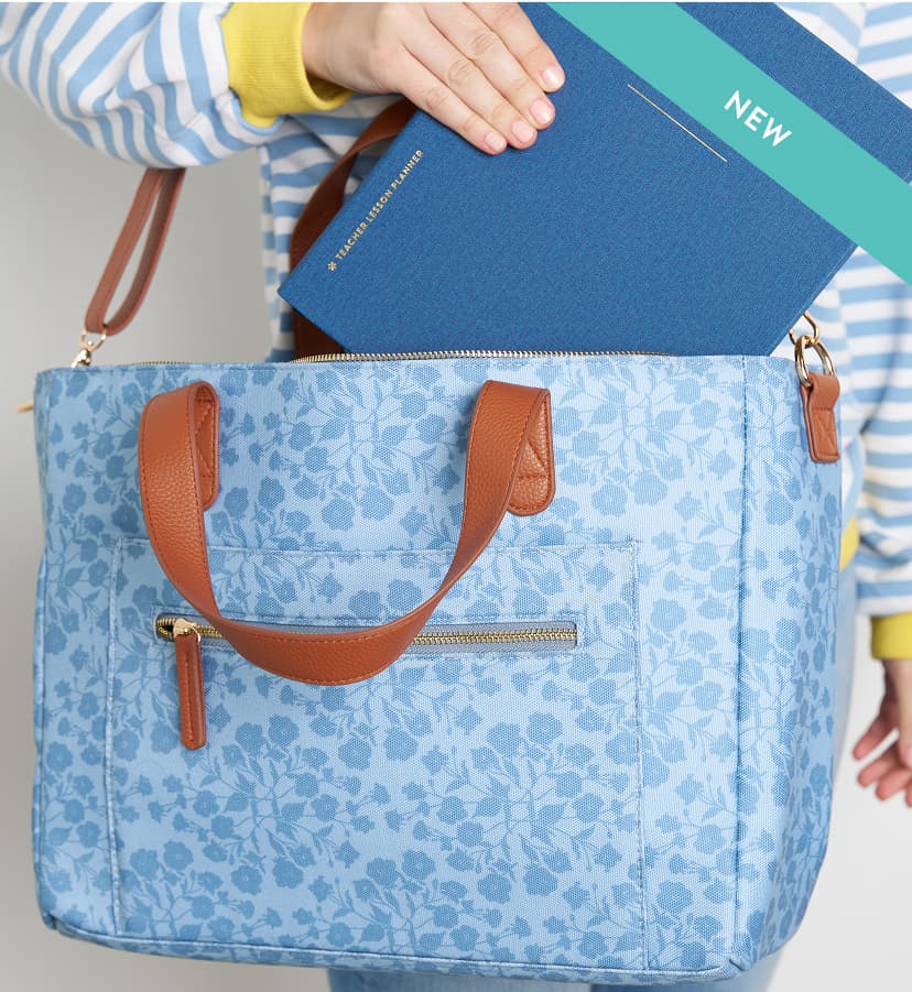 Softbound planner being put into a floral work tote. Click to shop high-quality work bags.