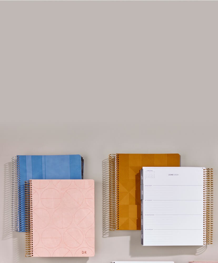 overhead view of coiled and softbound Focused planners and notebooks