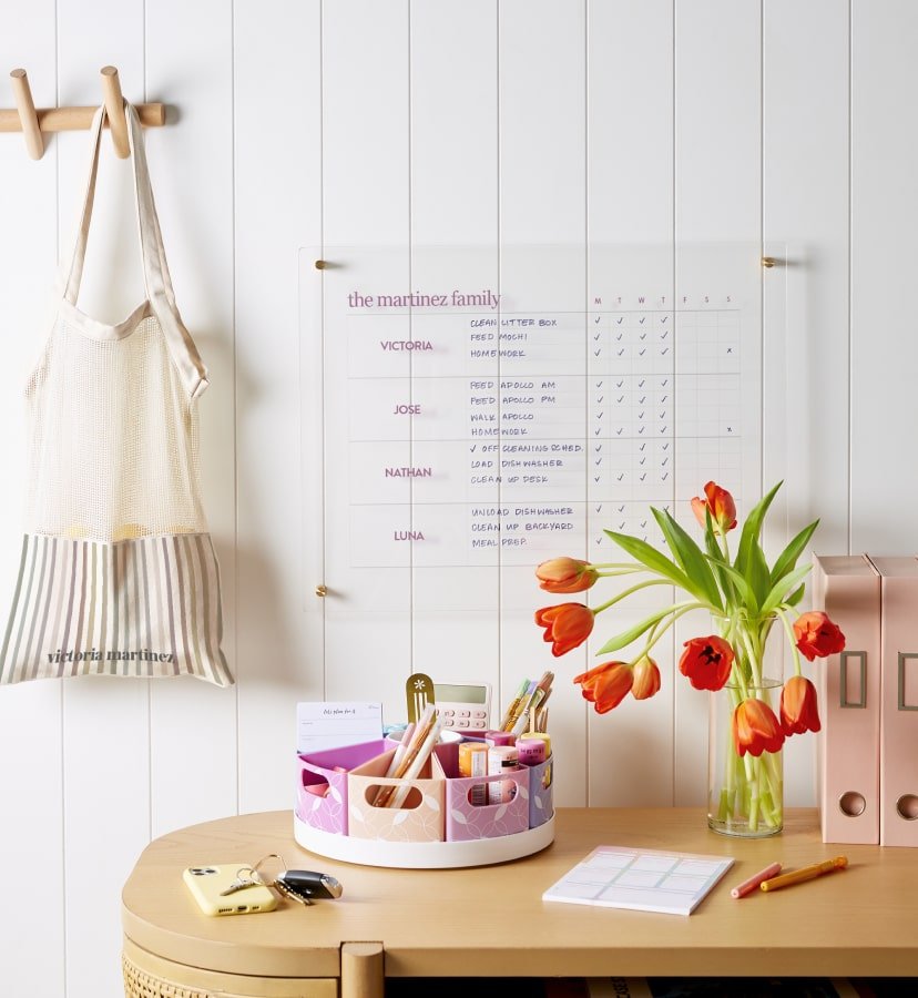 View of desk set up featuring desk accessories and wall calendar
